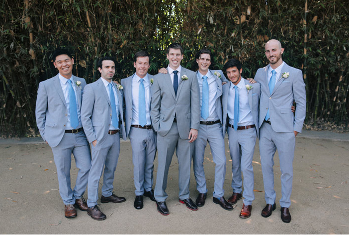 groomsmen and groom in grey suits with light blue dress shirts