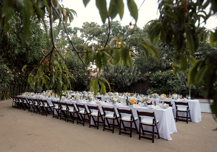 long table set in white with dark wood chairs