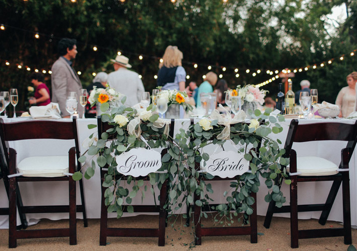 bride and groom chairs with eucalyptus