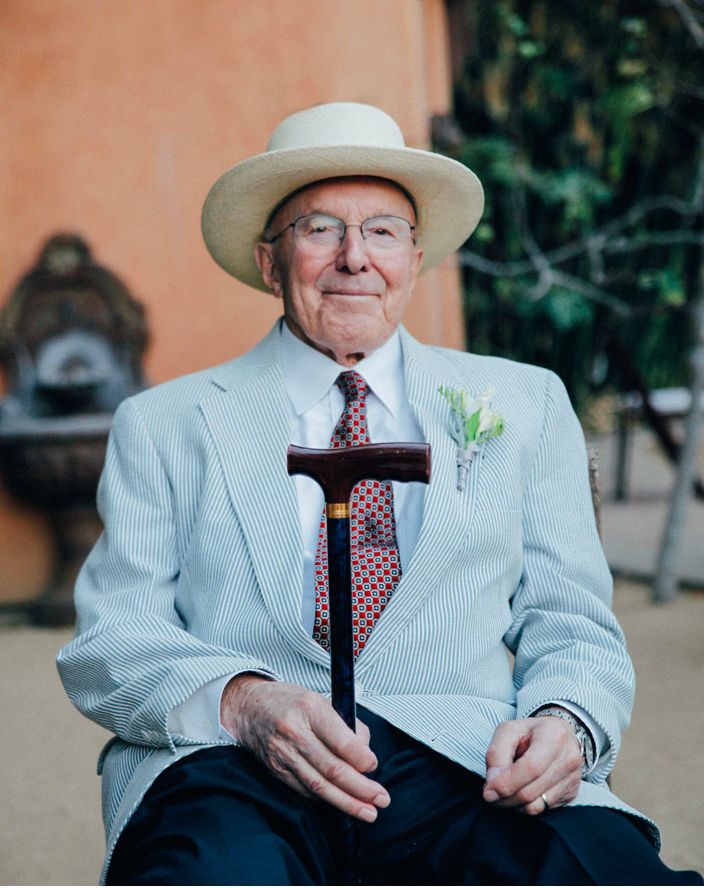 dapper grandfather of bride smiling with cane
