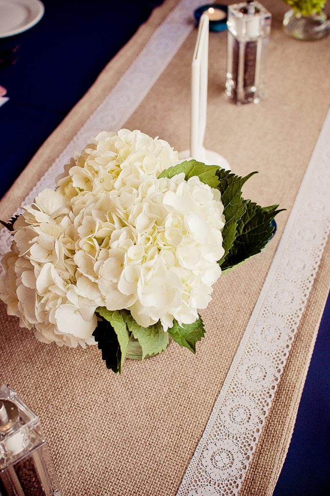 white hydrangea on burlap and lace runner